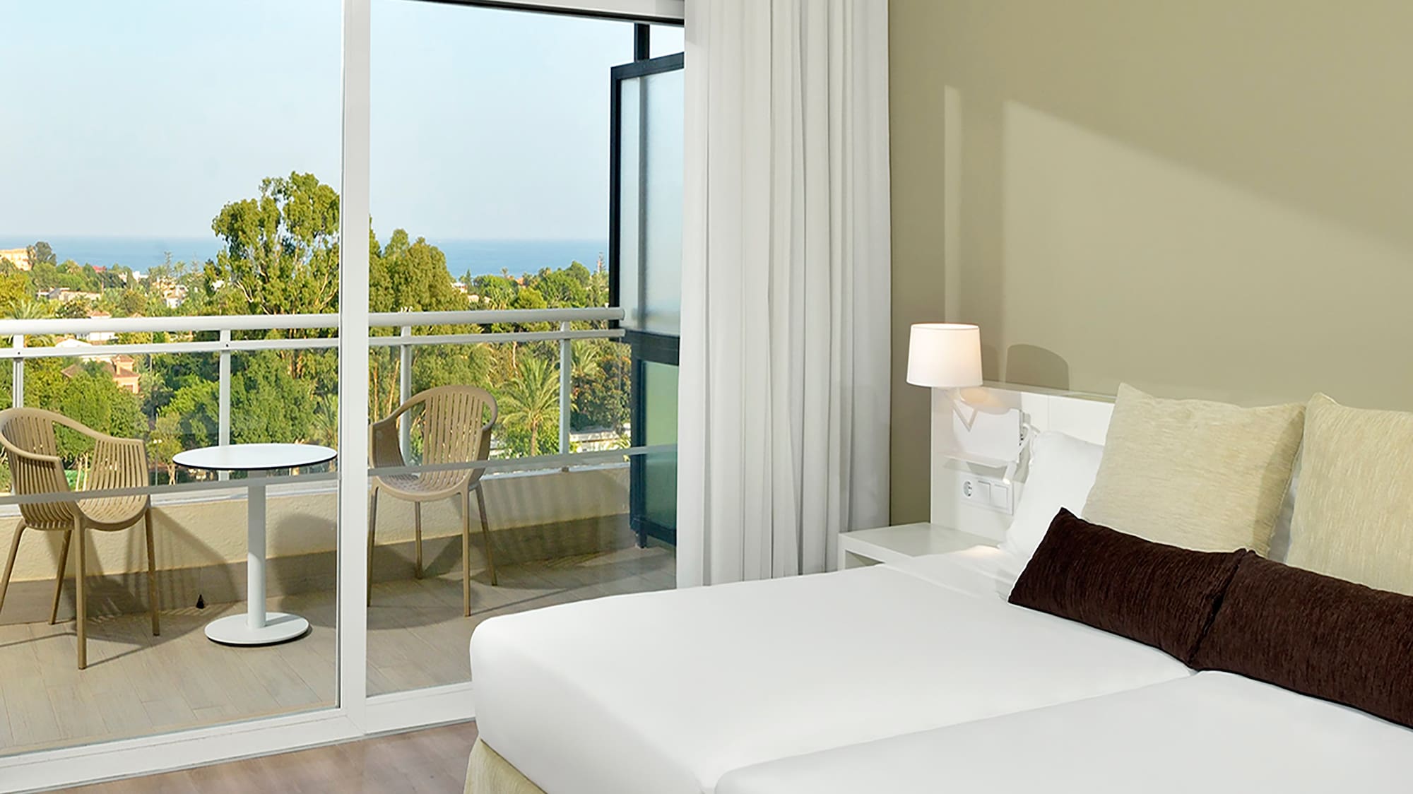 a bedroom with a glass door and a balcony