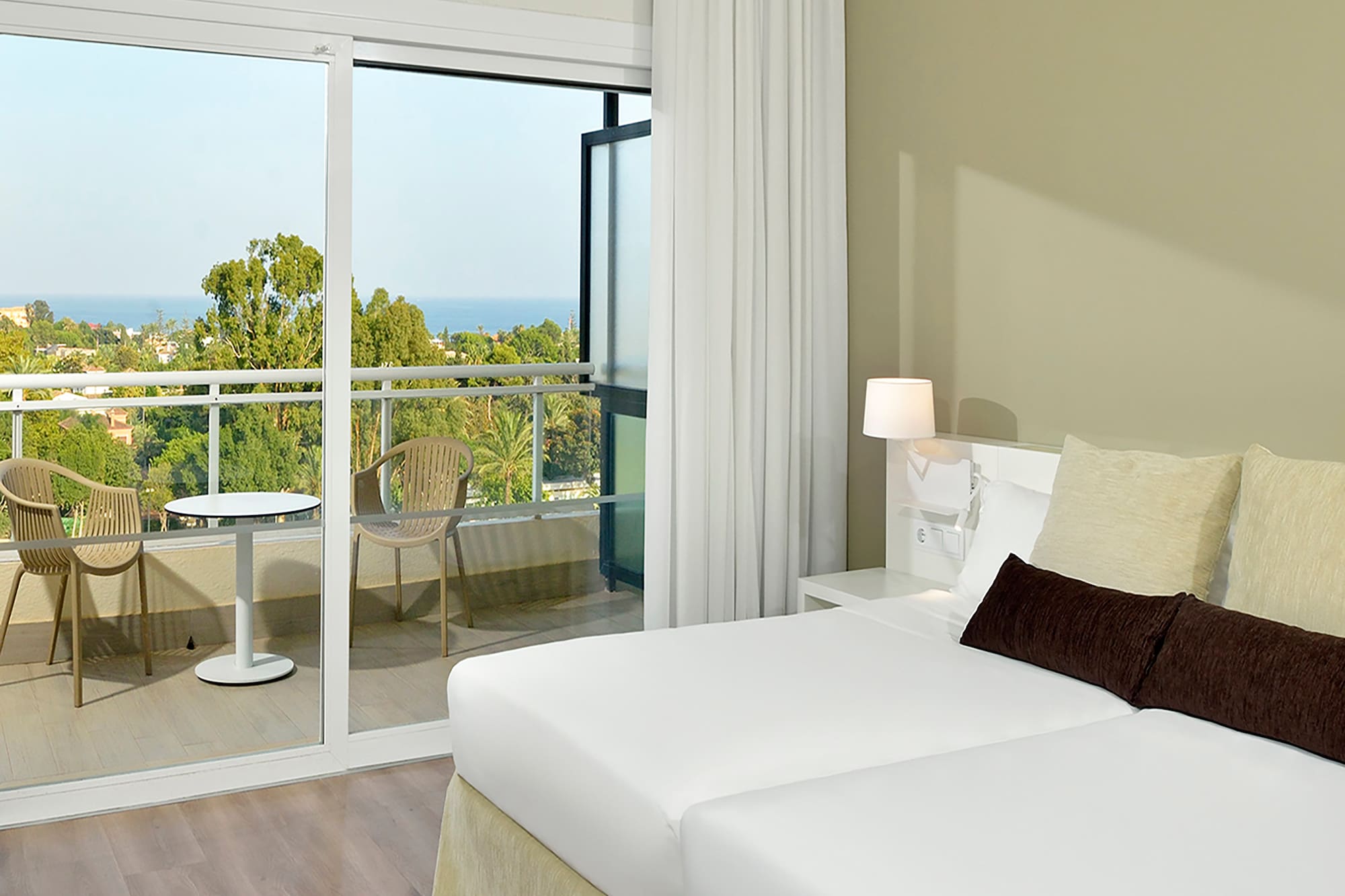 a bedroom with a glass door and a balcony