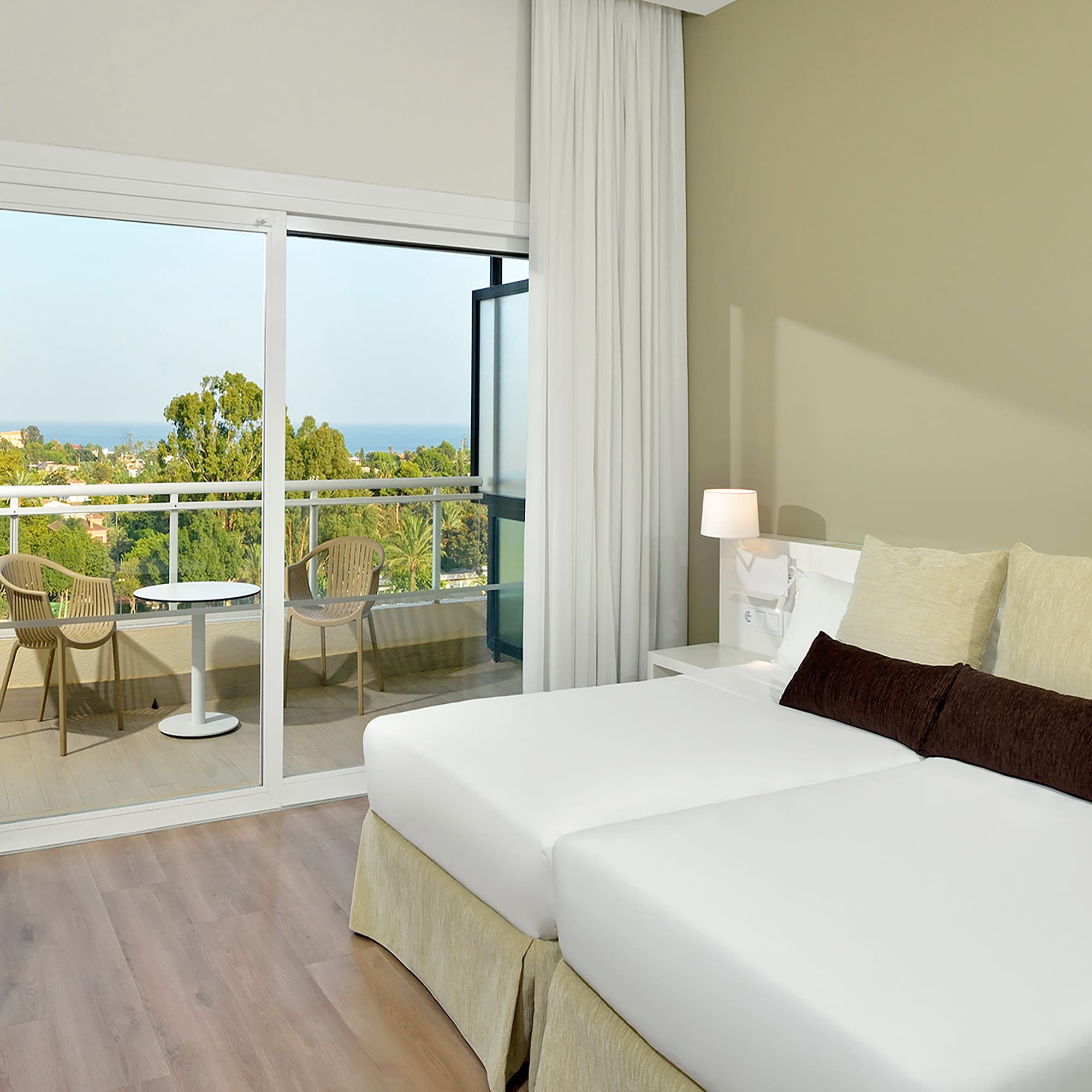 a bedroom with a glass door and a balcony