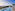 Rooftop infinity pool, lounge area, panoramic city and river view.