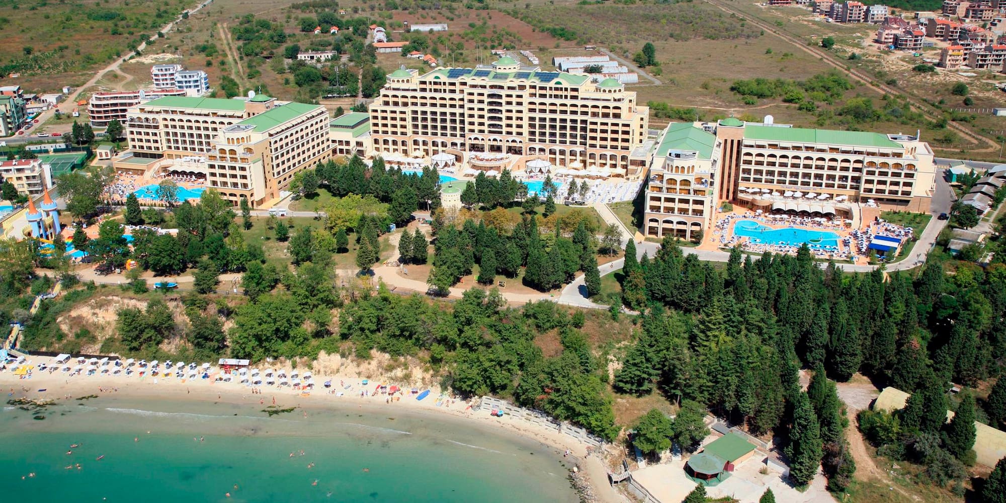 a aerial view of a beach with buildings and trees