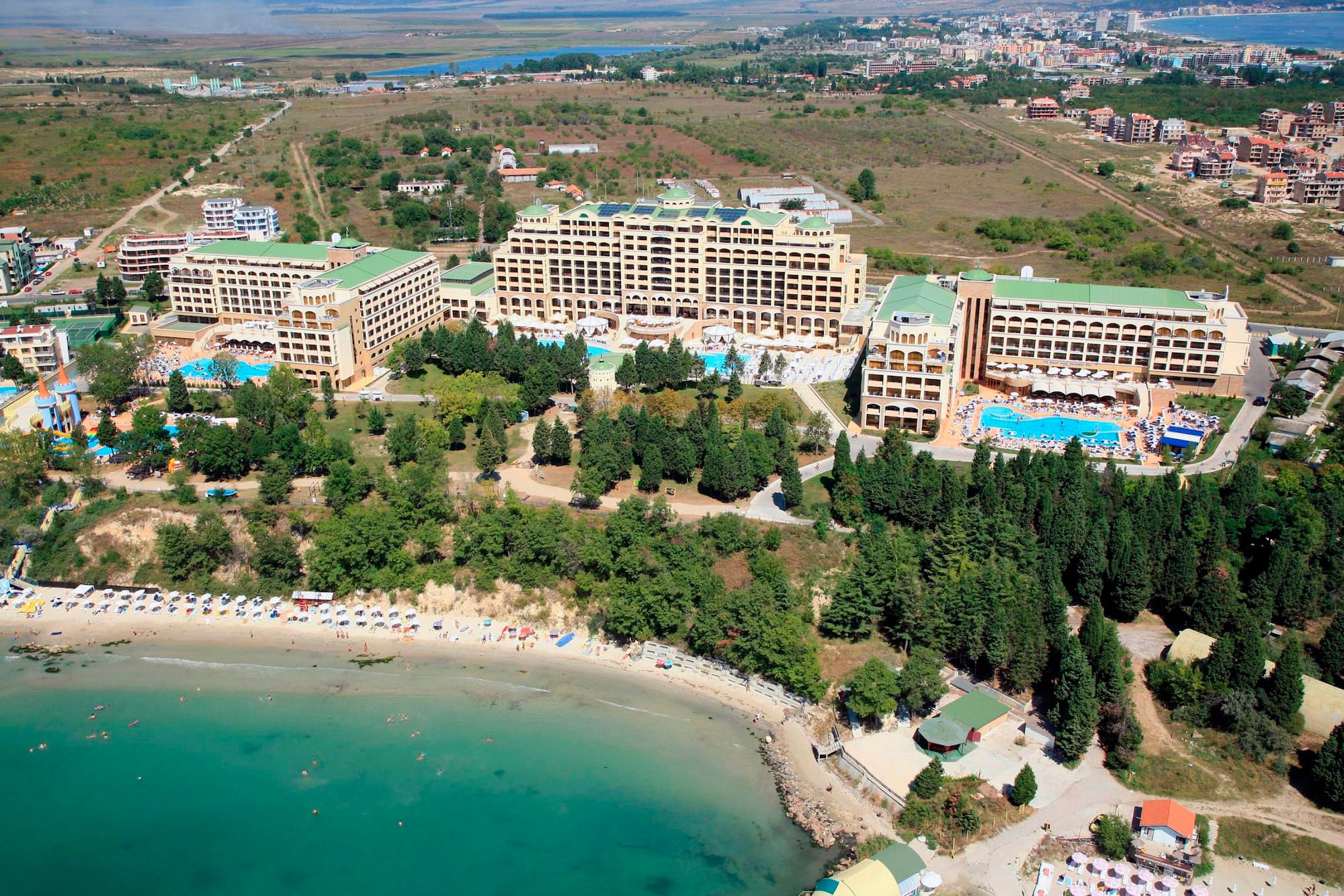 a aerial view of a beach with buildings and trees