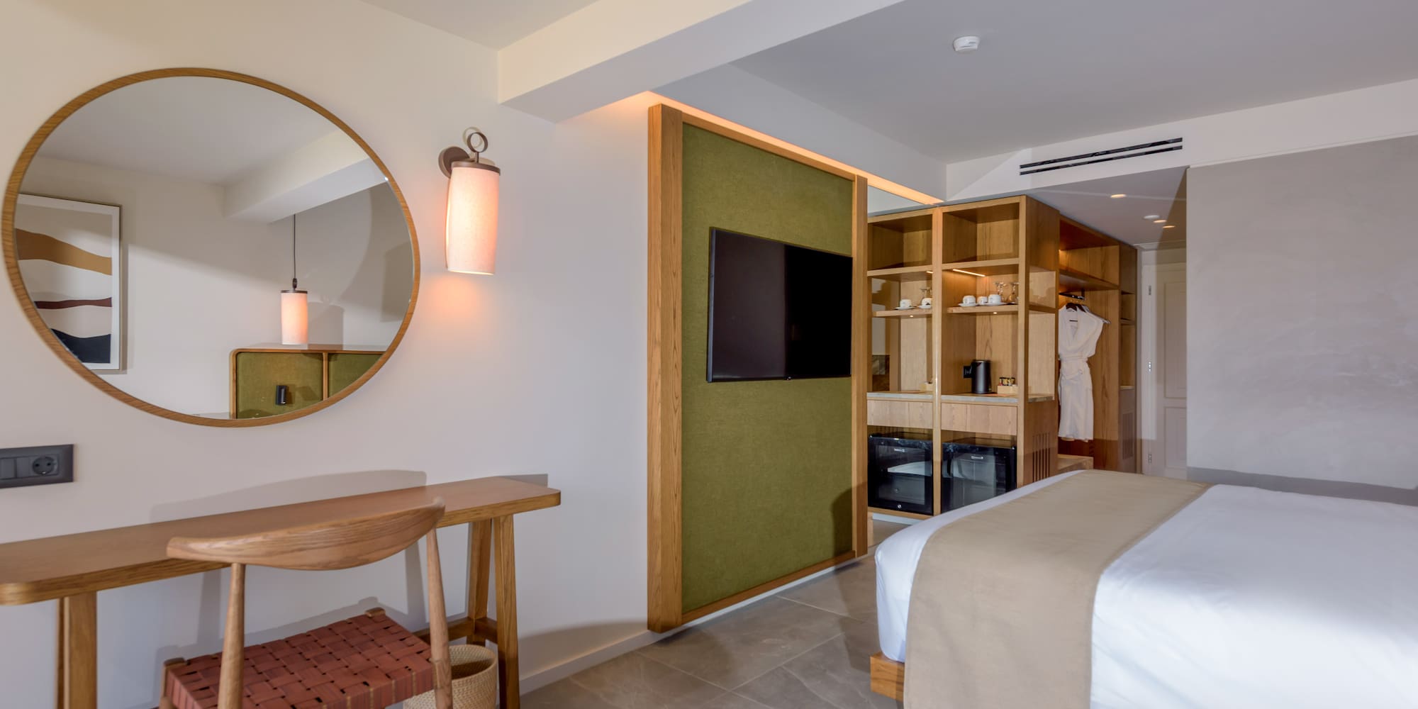 a room with a mirror and a bed.