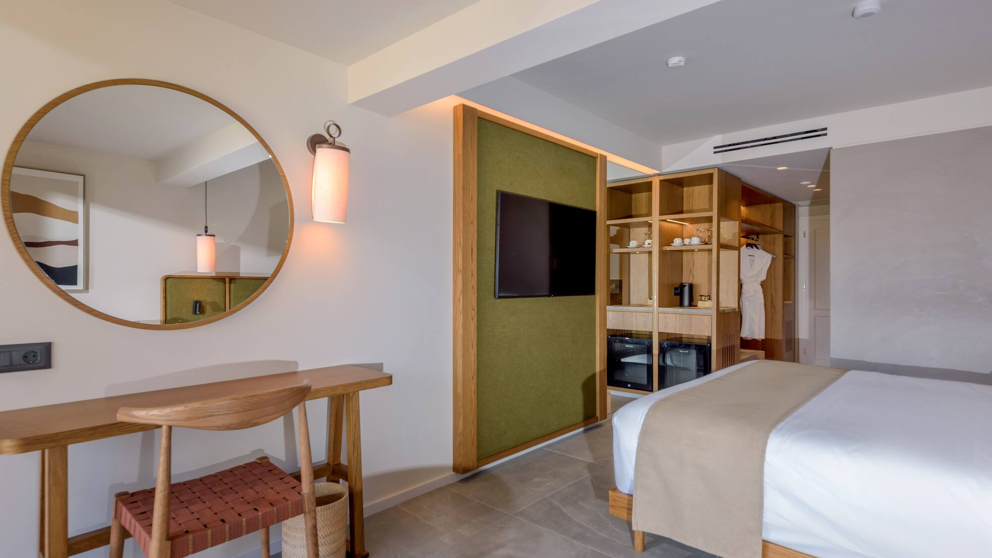 a room with a mirror and a bed.