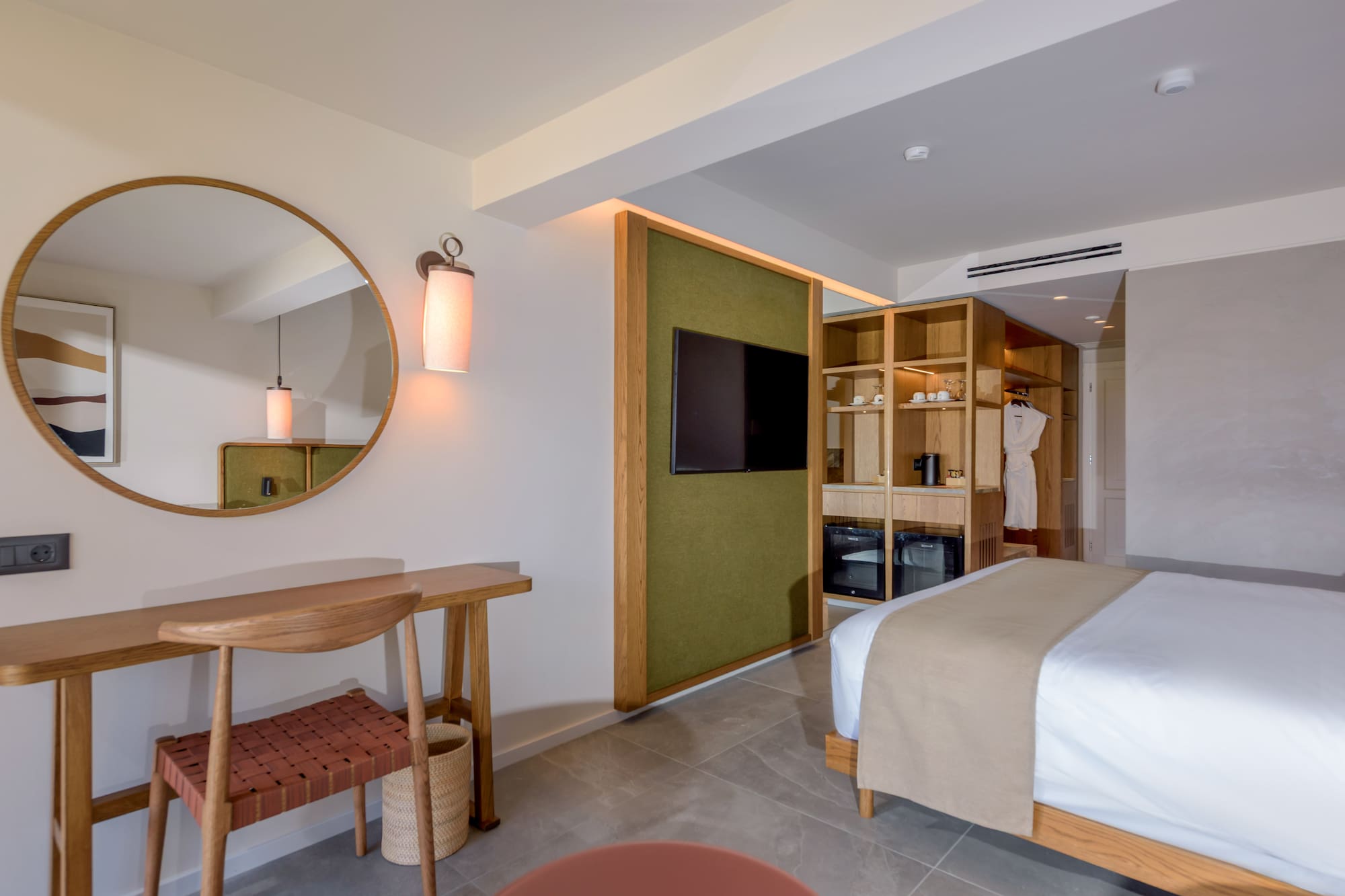 a room with a mirror and a bed.