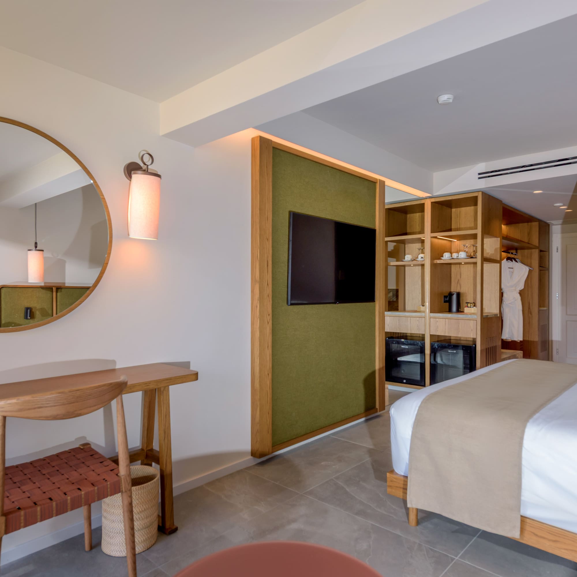 a room with a mirror and a bed.