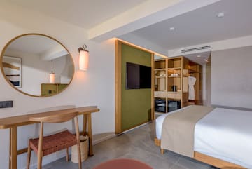 a room with a mirror and a bed.