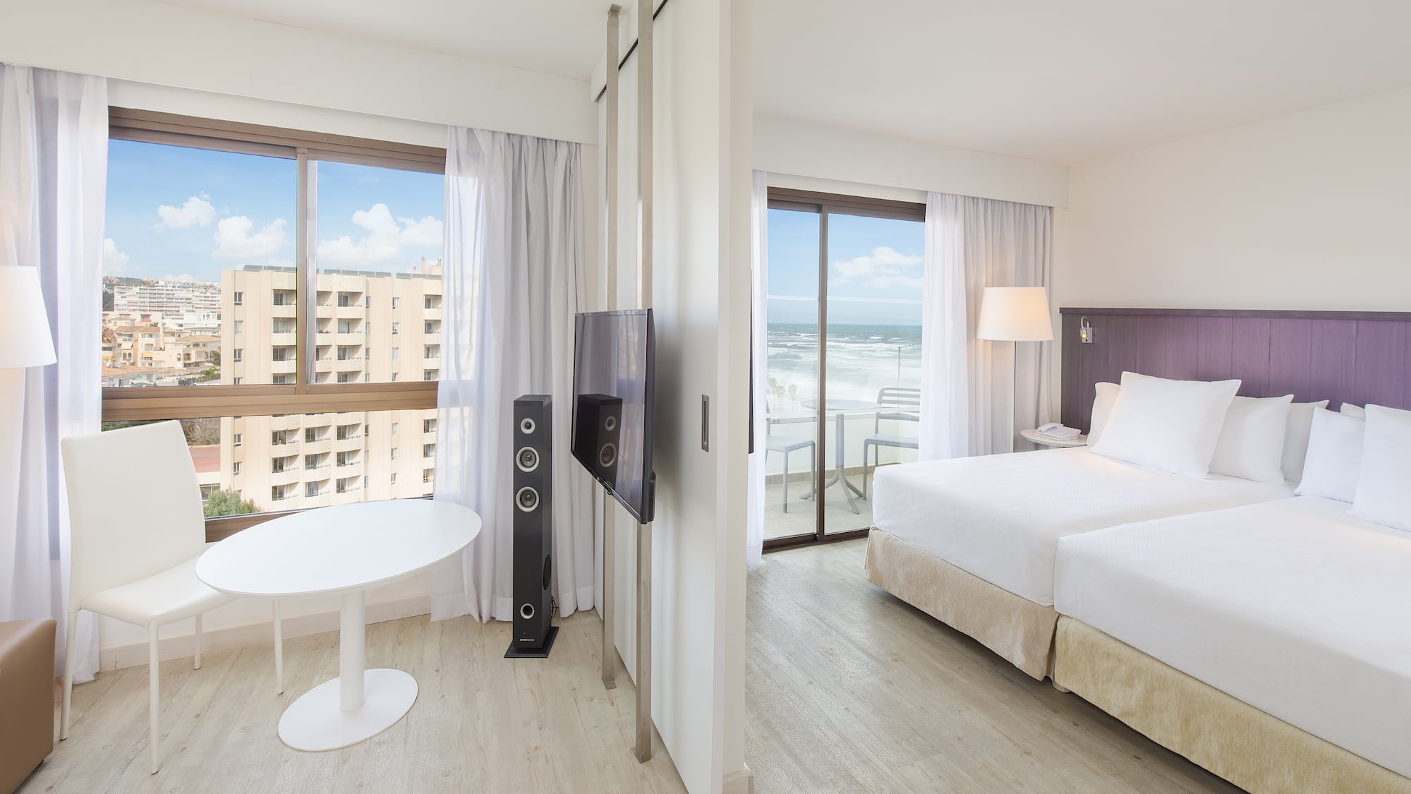 a room with a bed and a television