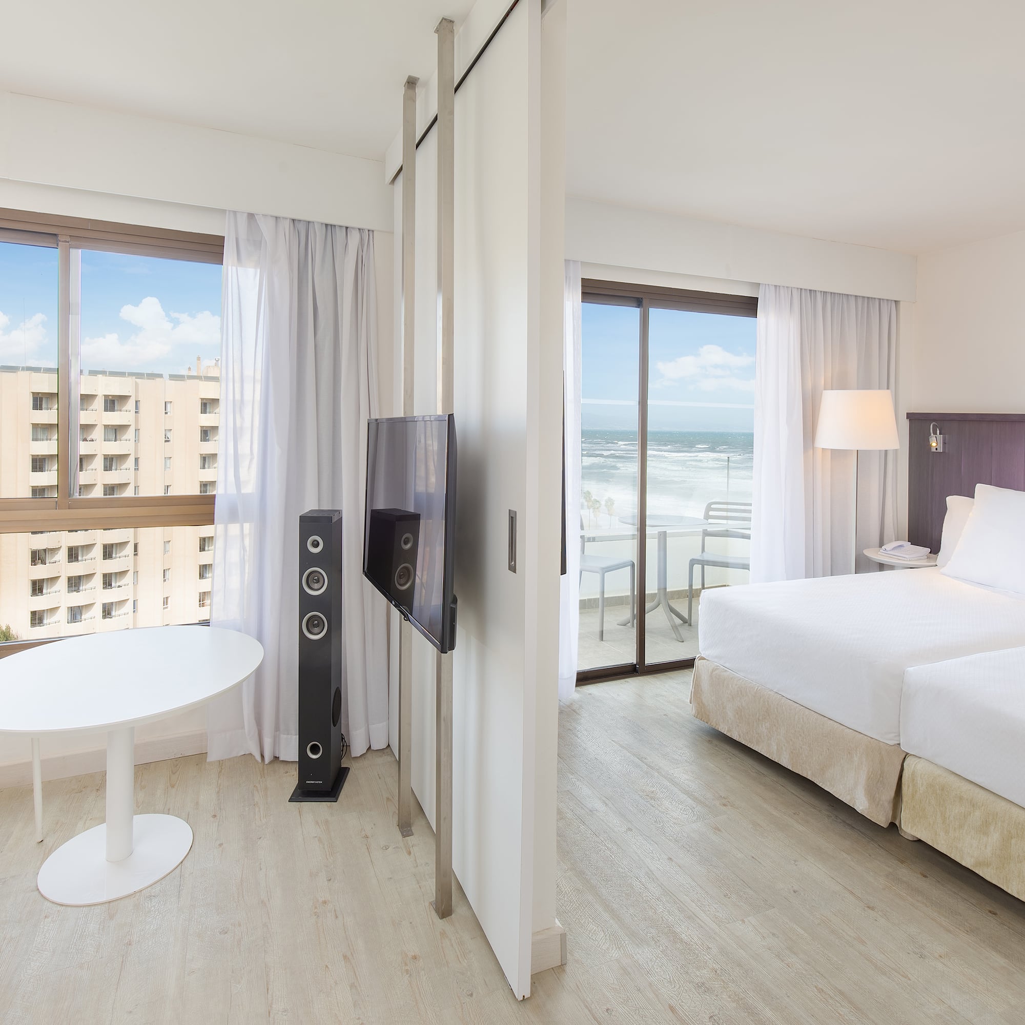 a room with a bed and a television