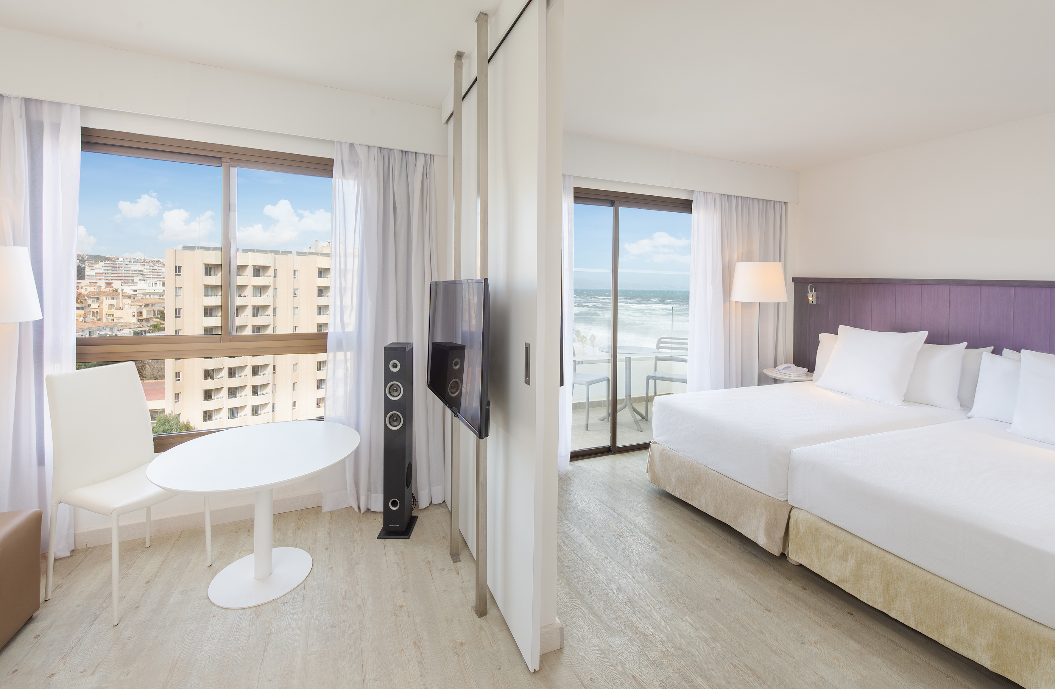 a room with a bed and a television