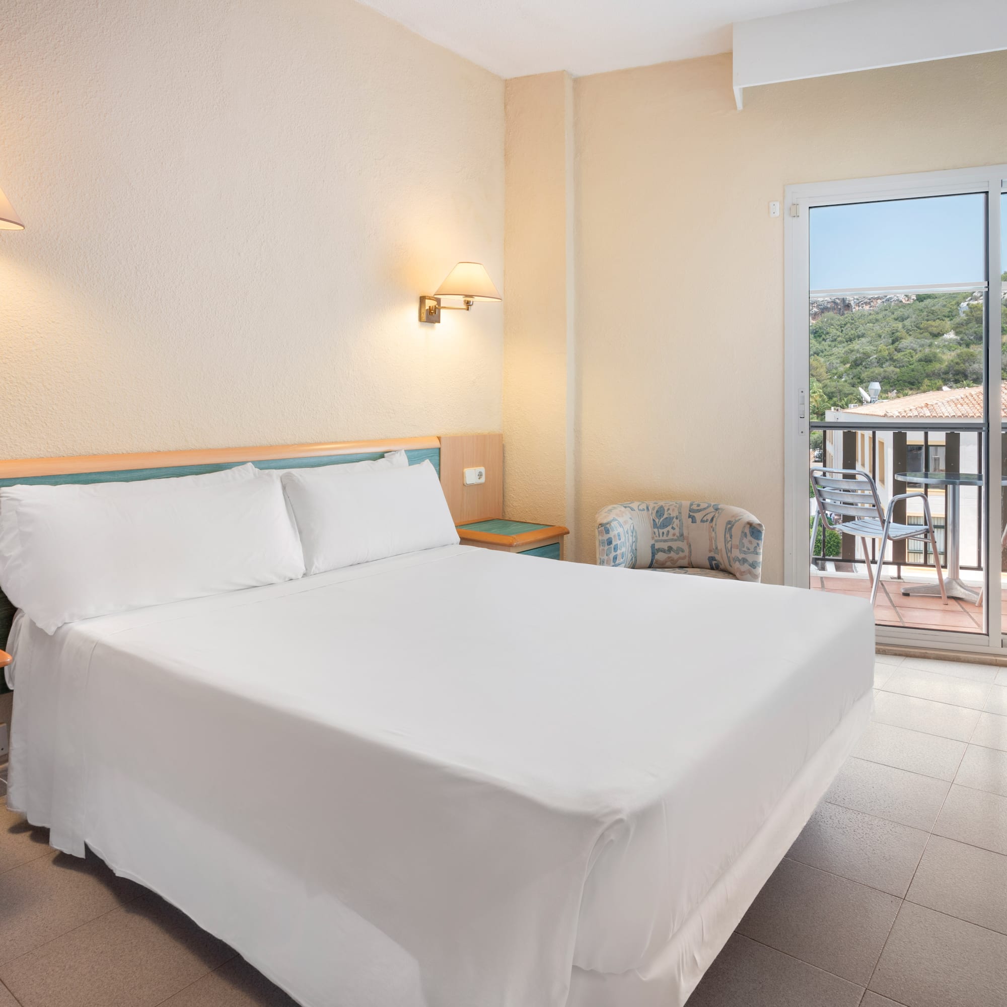 a bed in a room with a glass door