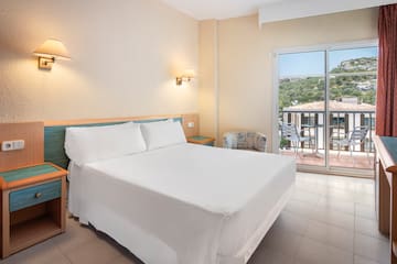 a bed in a room with a glass door