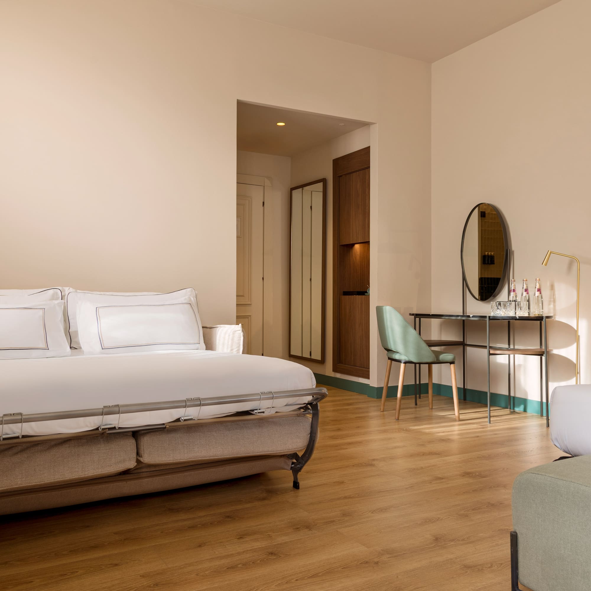 a bedroom with a bed and a mirror