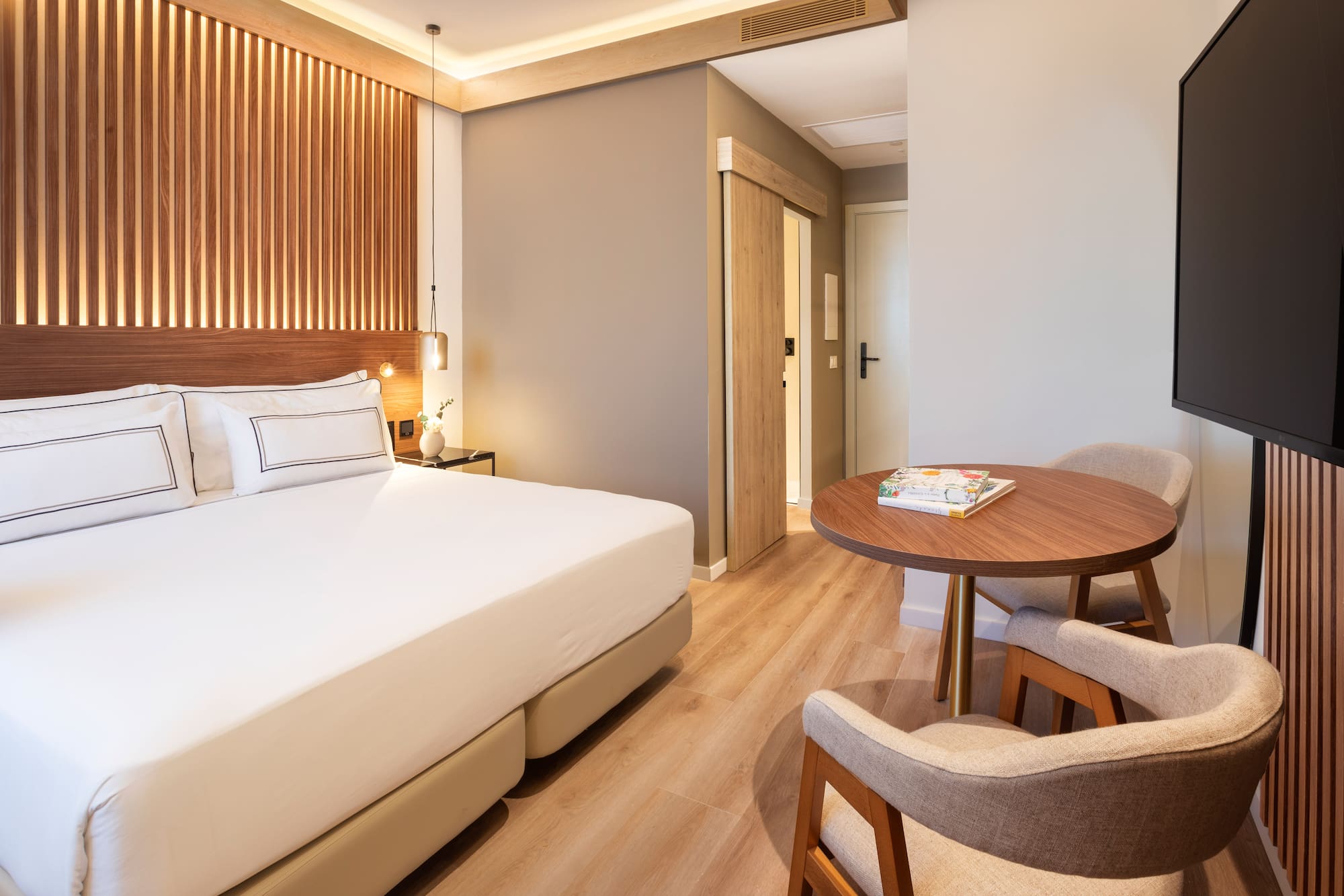 a room with a bed and chairs