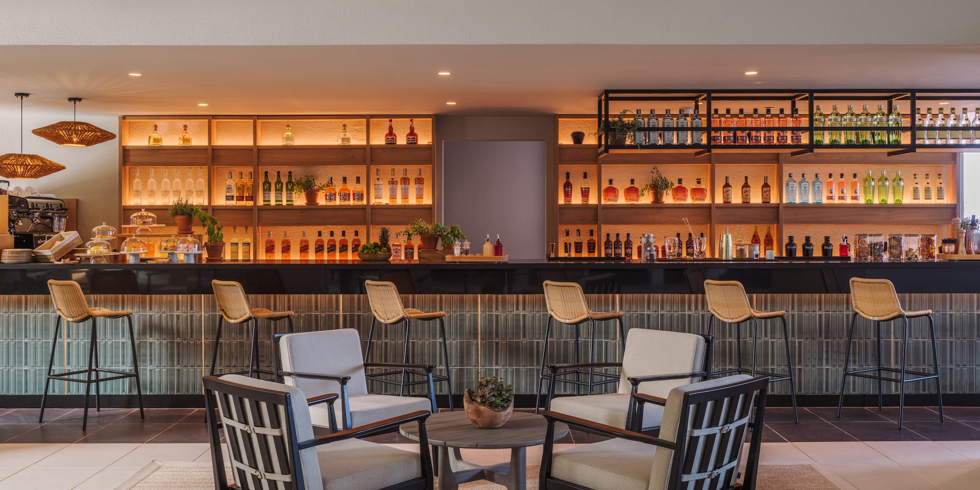 a room with a bar and chairs