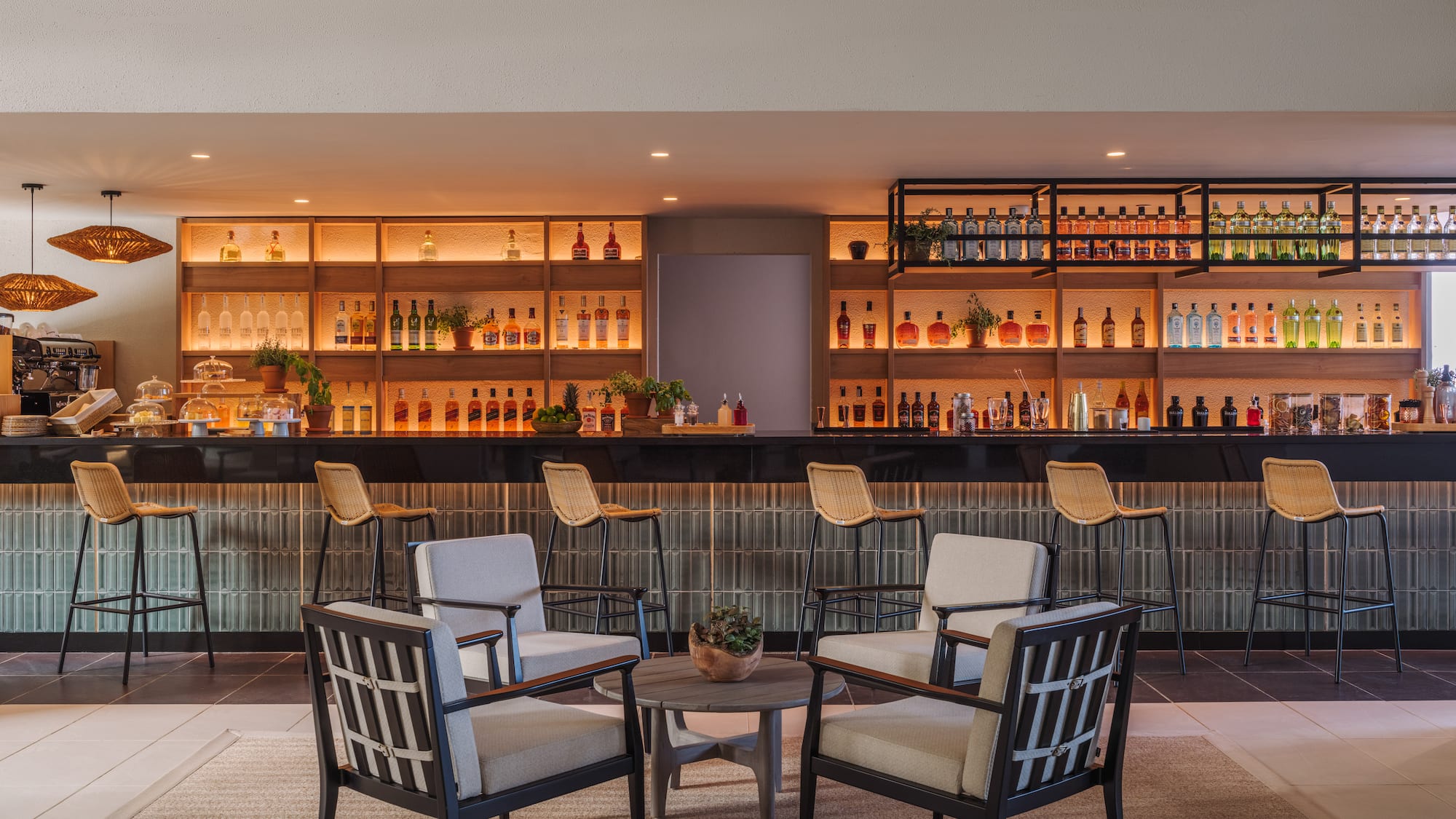 a room with a bar and chairs