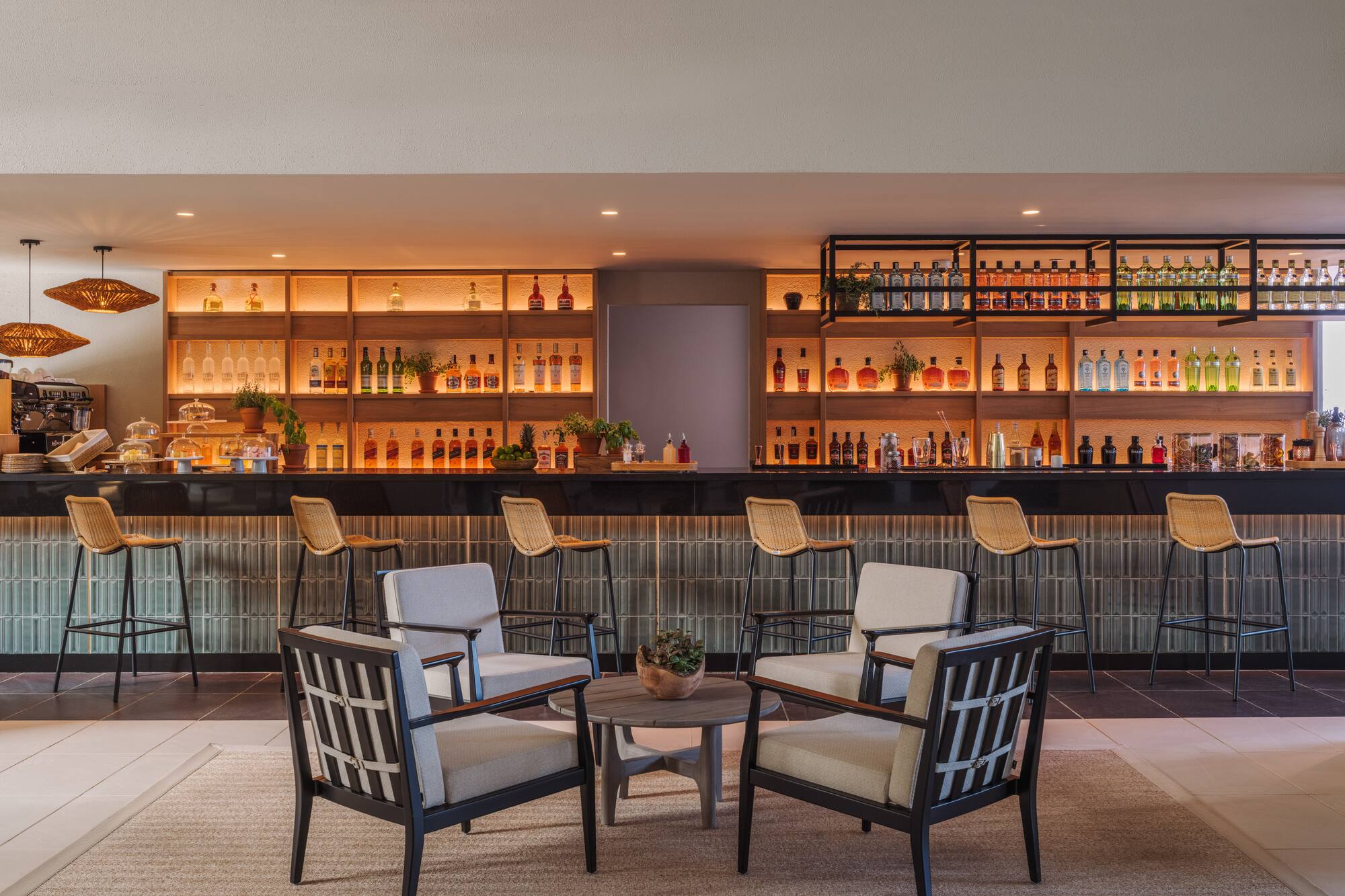 a room with a bar and chairs