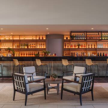 a room with a bar and chairs