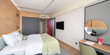 a bedroom with a bed and a desk