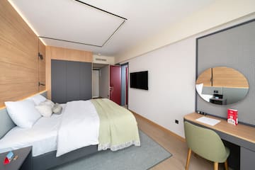 a bedroom with a bed and a desk