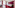 Red hotel room with large bed, patterned carpet, desk, and burgundy wall.