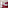 Red hotel room with large bed, patterned carpet, desk, and burgundy wall.