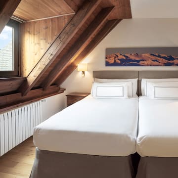 a bedroom with a wooden ceiling and a window