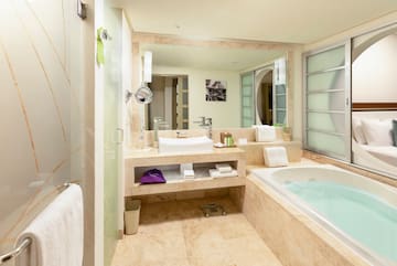 a bathroom with a tub and a mirror