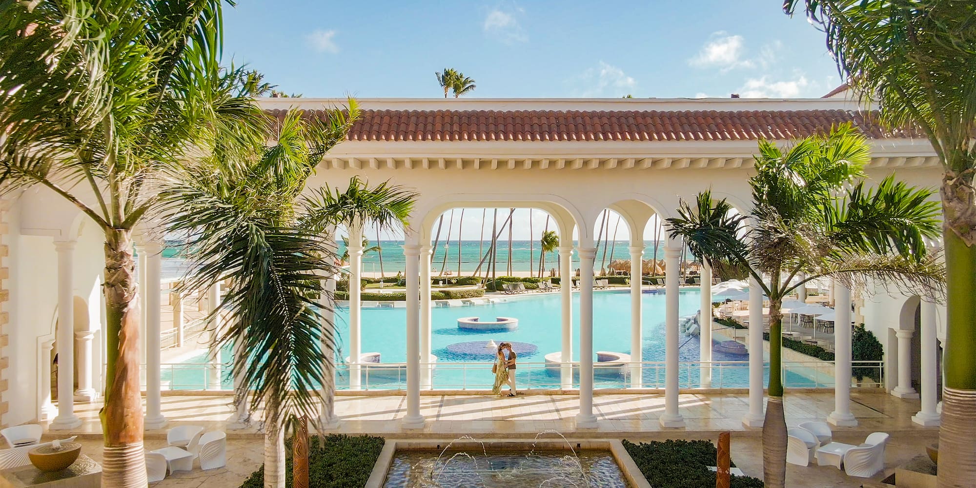 a pool with a man and woman in the background