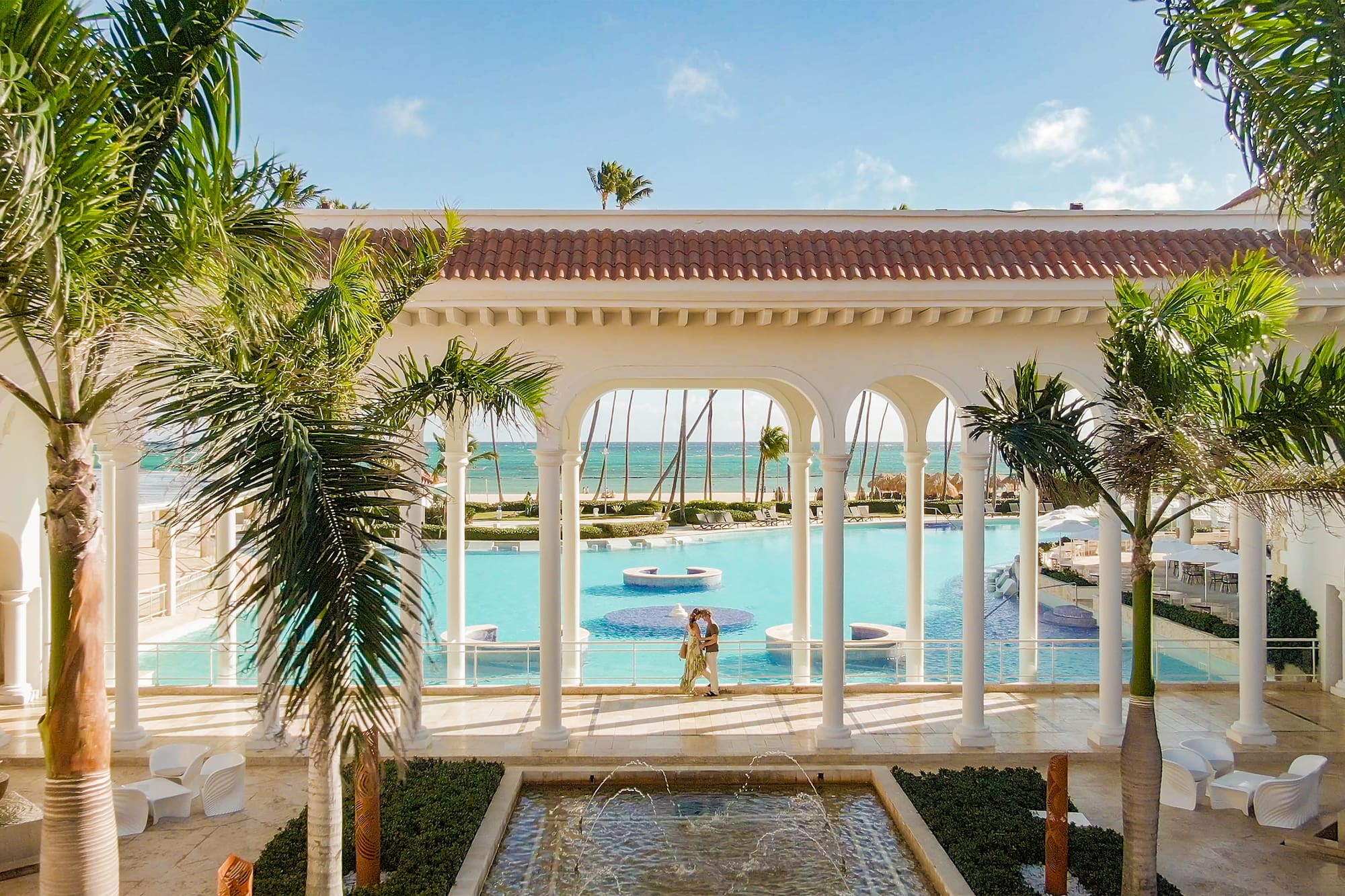 a pool with a man and woman in the background