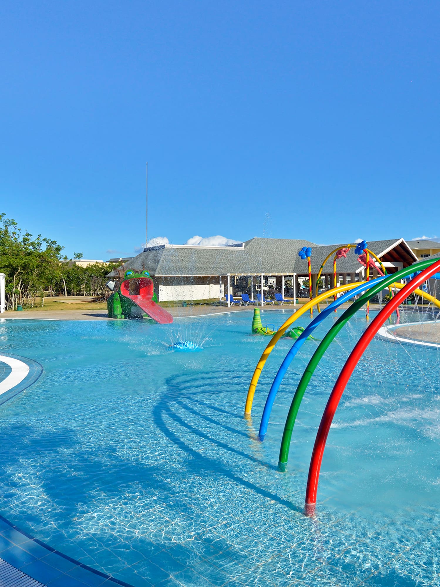 a pool with colorful water slides and a slide