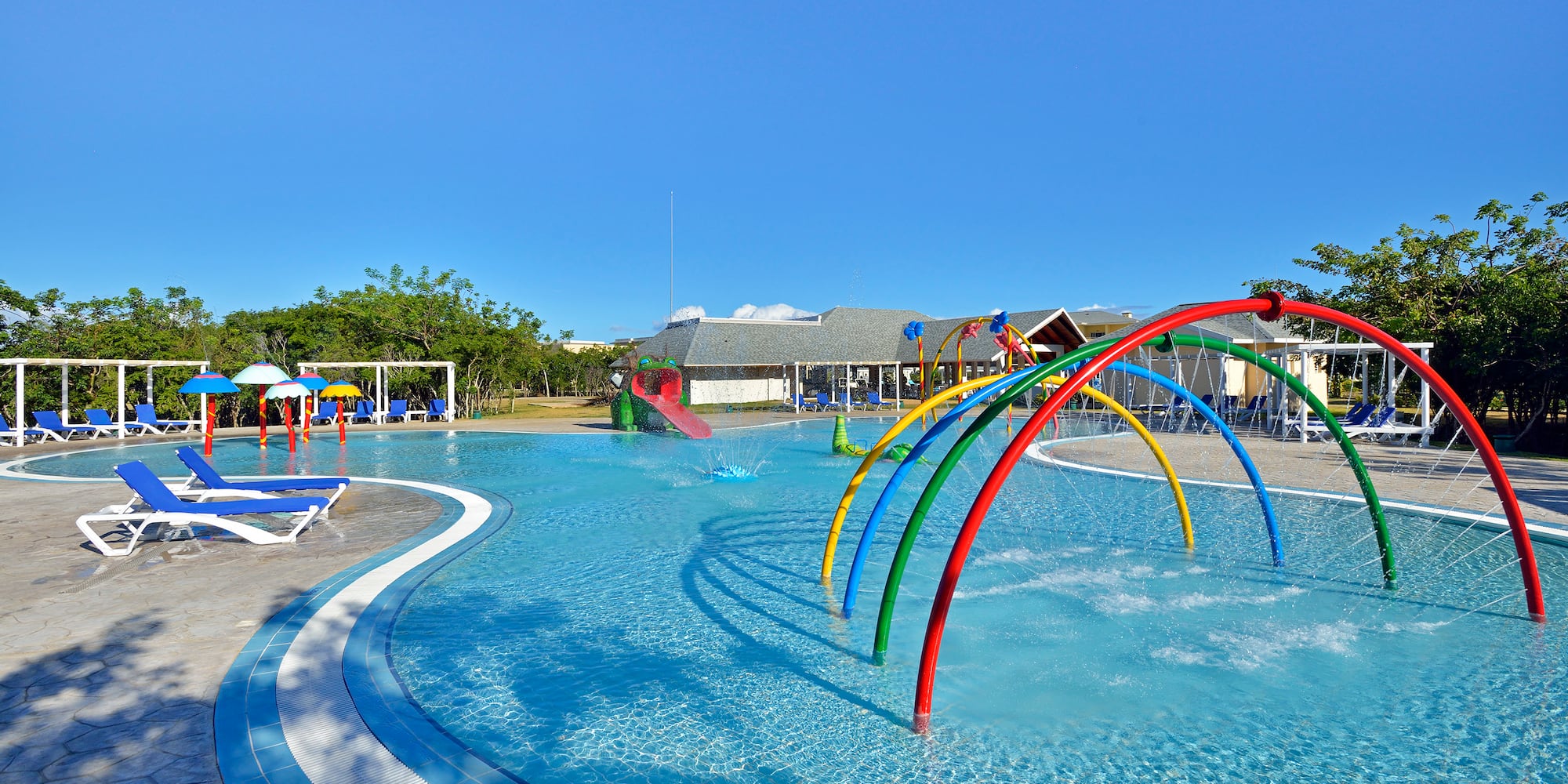 a pool with colorful water slides and a slide