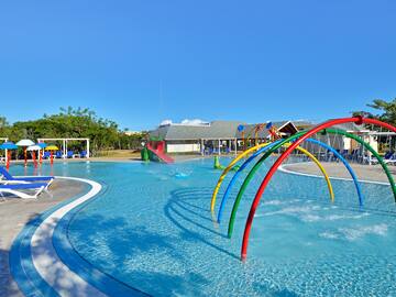 a pool with colorful water slides and a slide