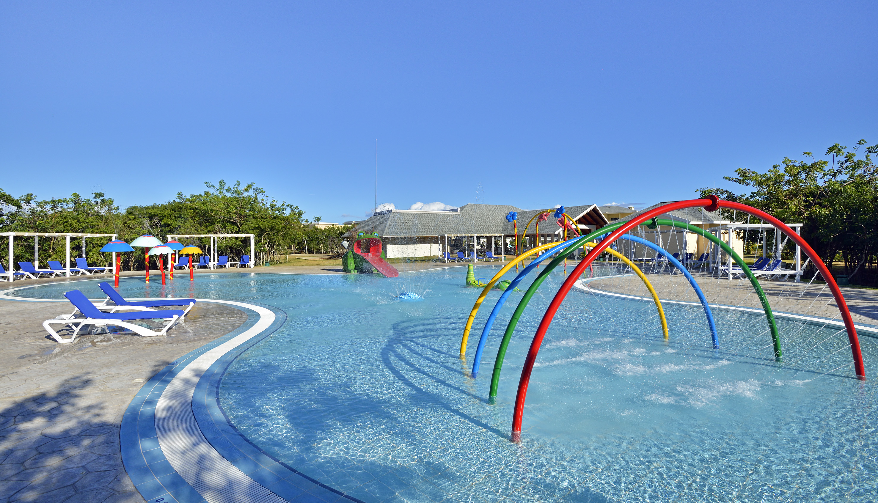 a pool with colorful water slides and a slide
