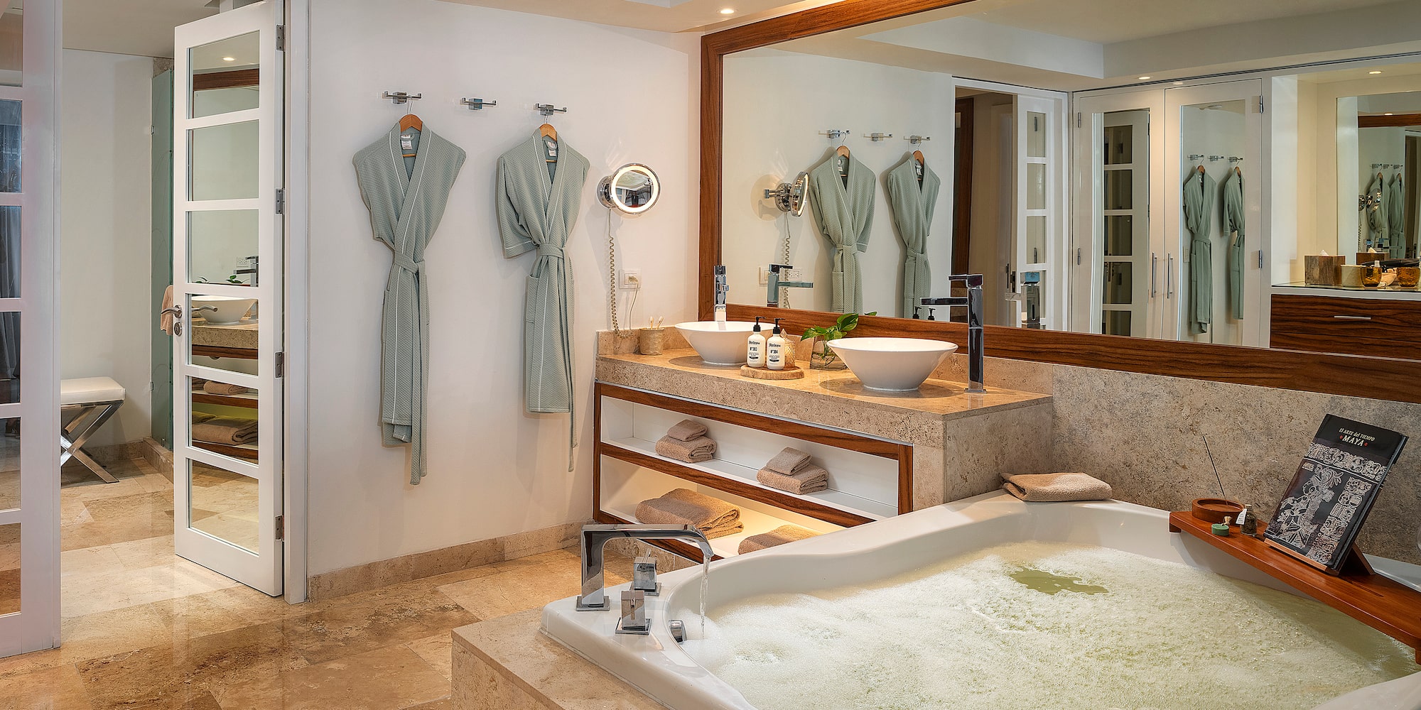 a bathroom with a large tub and a large mirror