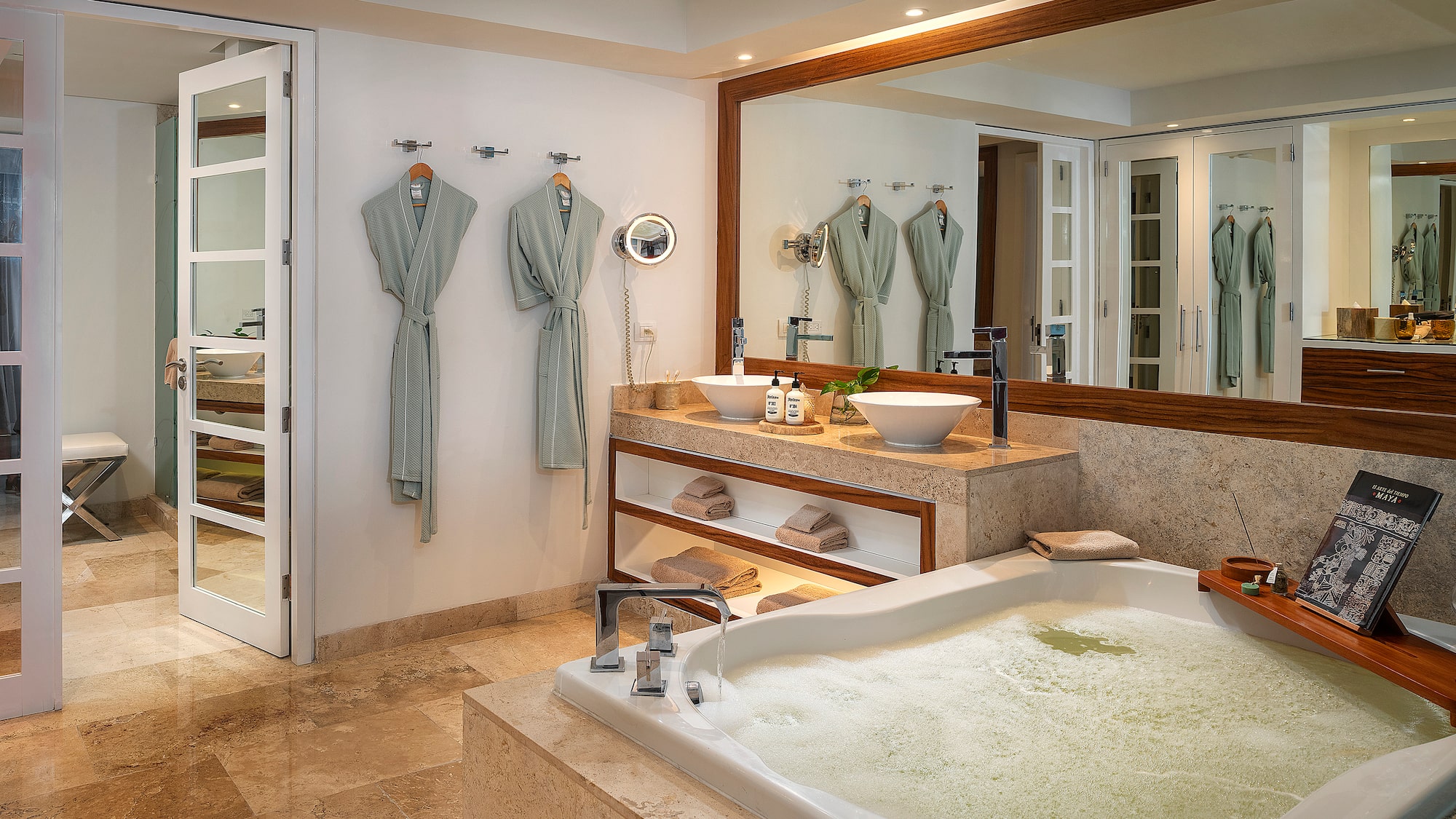 a bathroom with a large tub and a large mirror