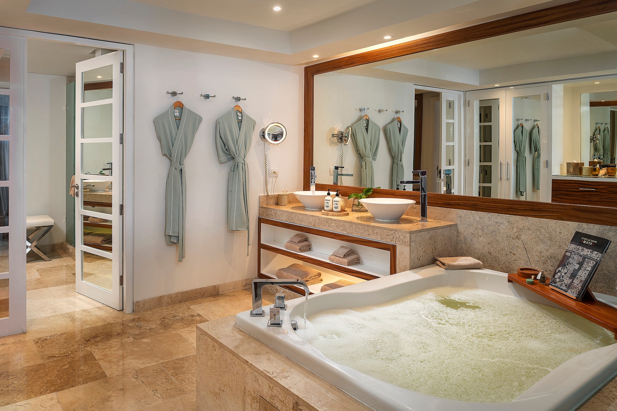 a bathroom with a large tub and a large mirror