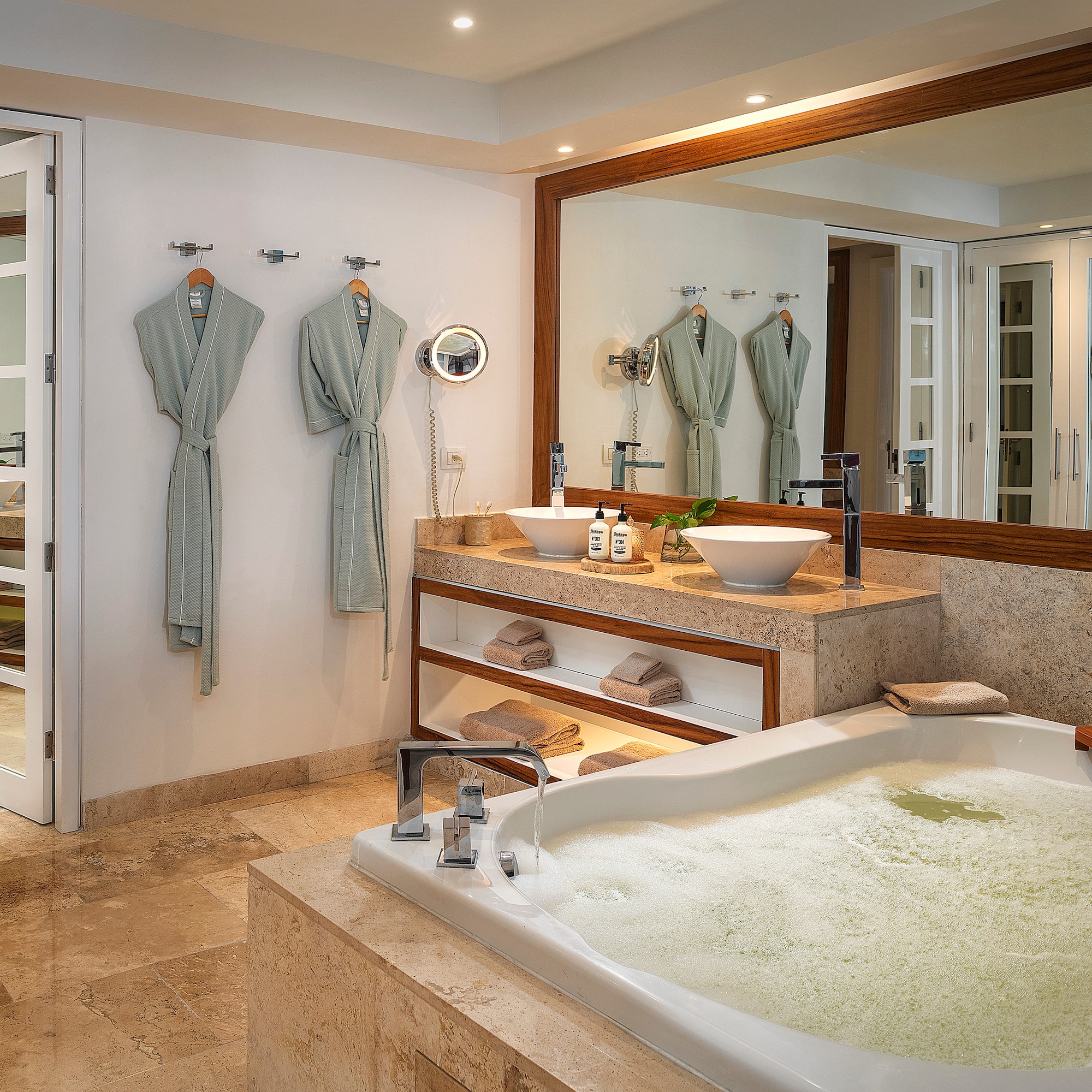a bathroom with a large tub and a large mirror