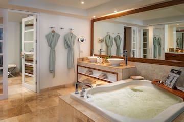 a bathroom with a large tub and a large mirror