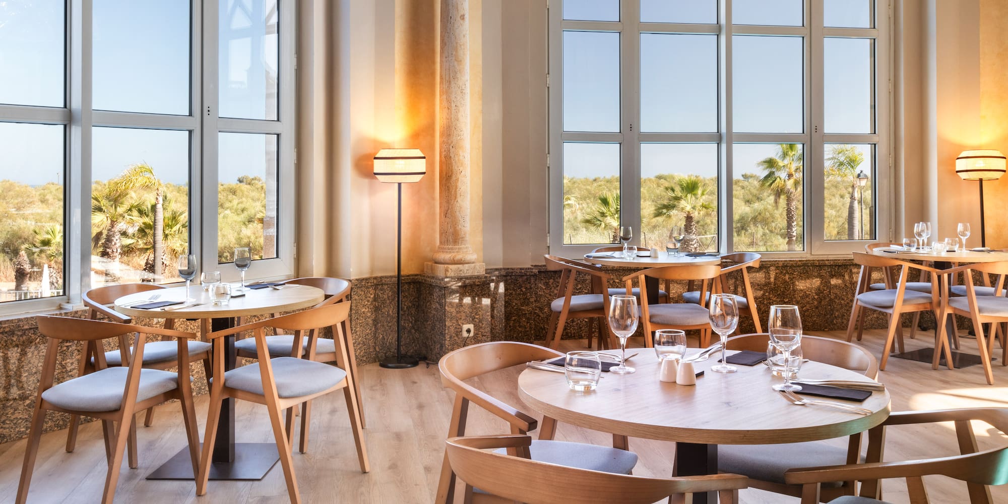a room with tables and chairs and a window