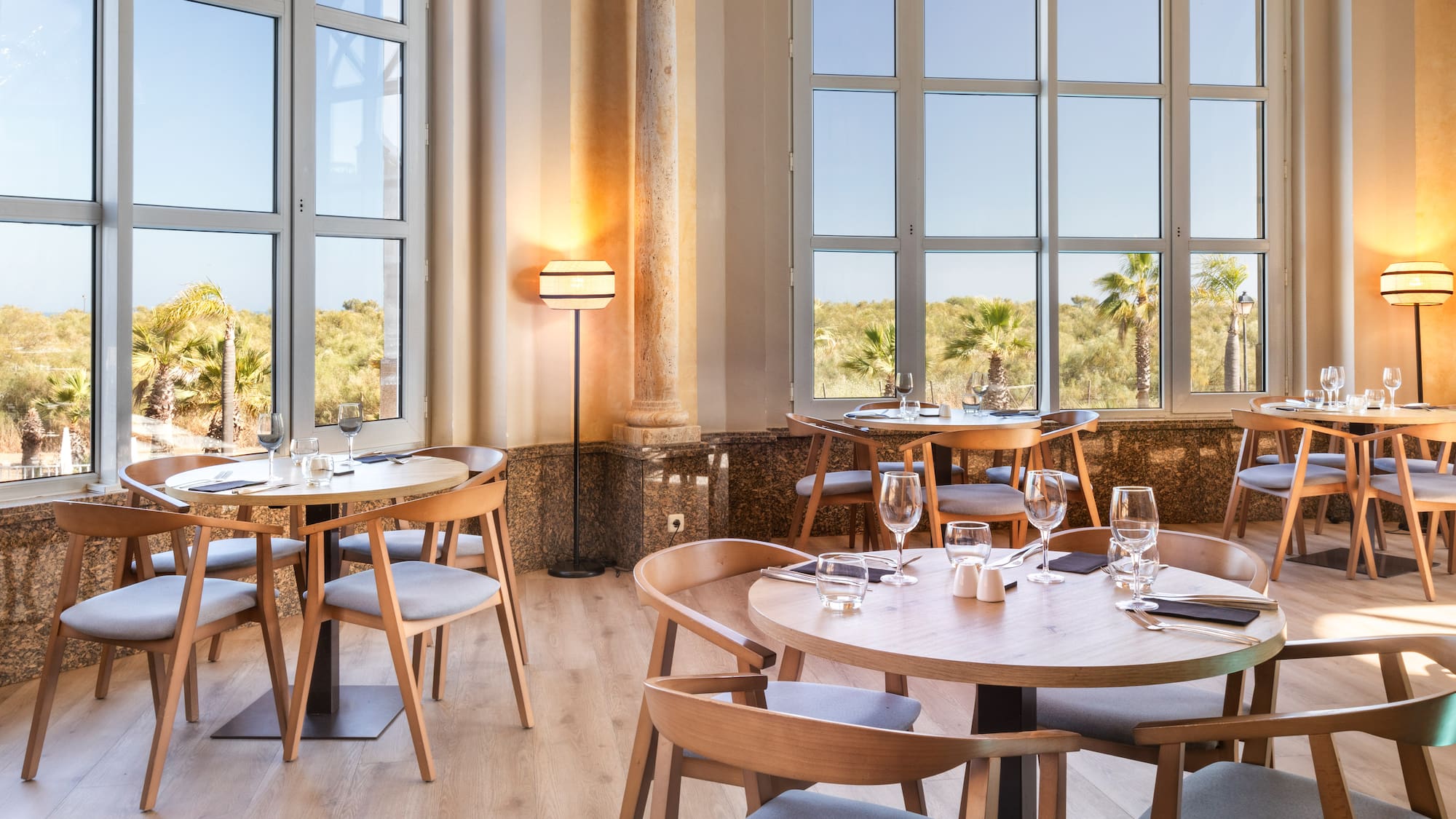 a room with tables and chairs and a window