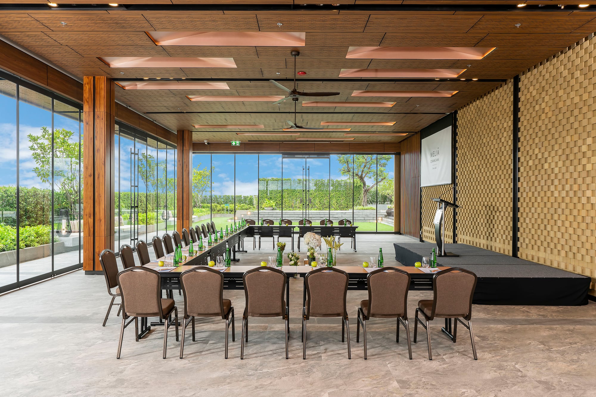 Spacious Melia conference room with garden view, U-shaped setup, stage.