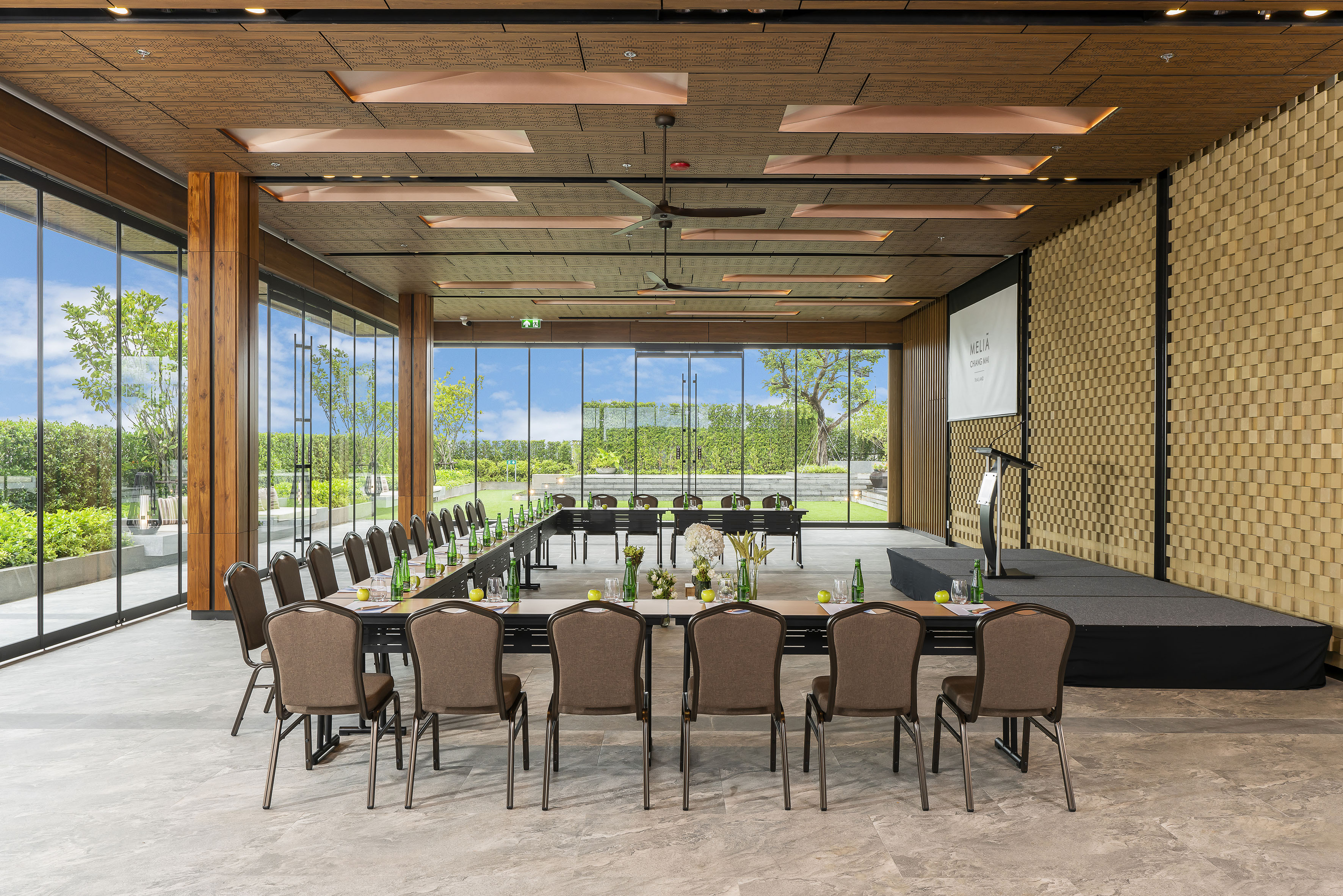 Spacious Melia conference room with garden view, U-shaped setup, stage.