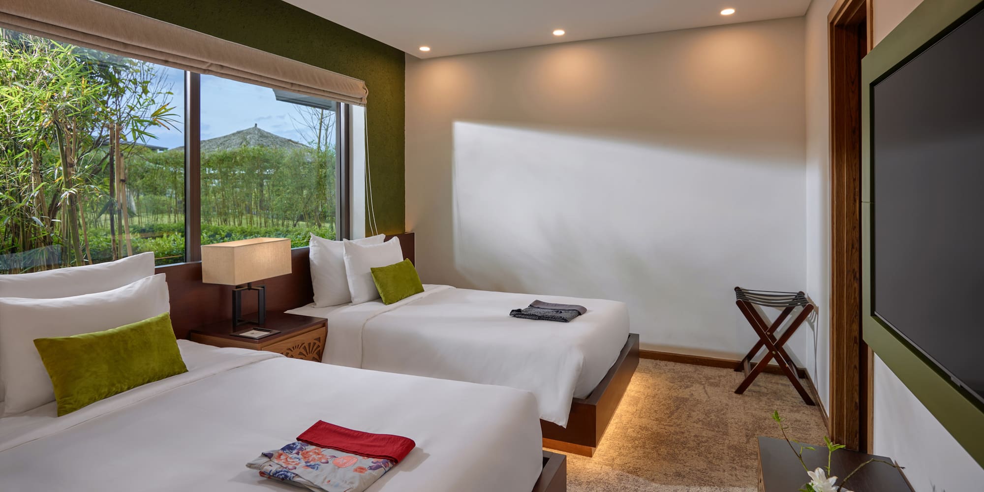 a room with two beds and a window