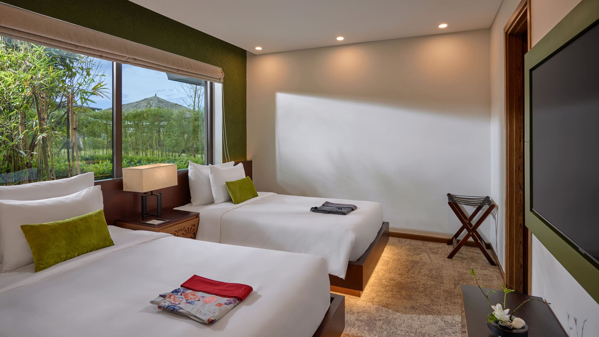 a room with two beds and a window