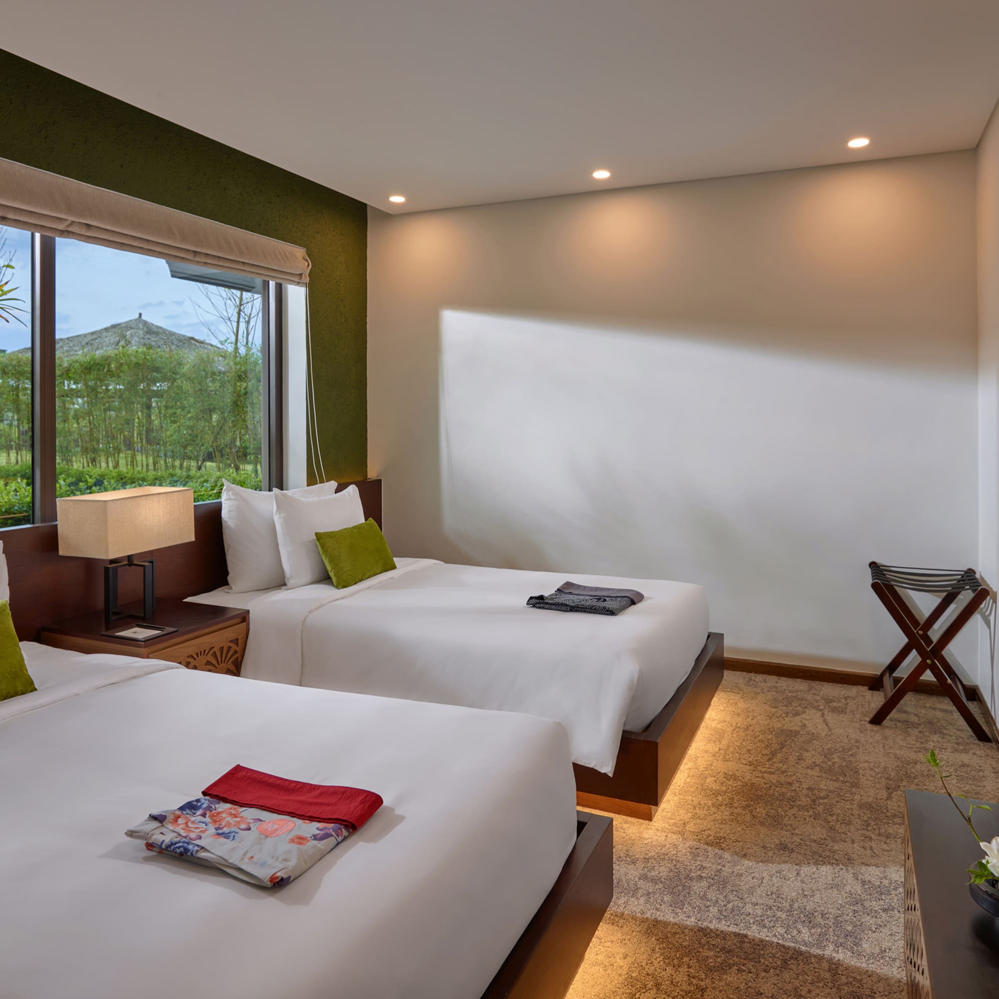 a room with two beds and a window