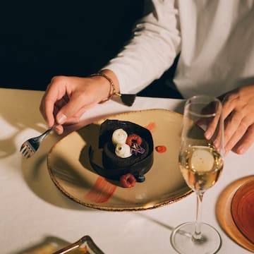 a person eating a dessert on a plate