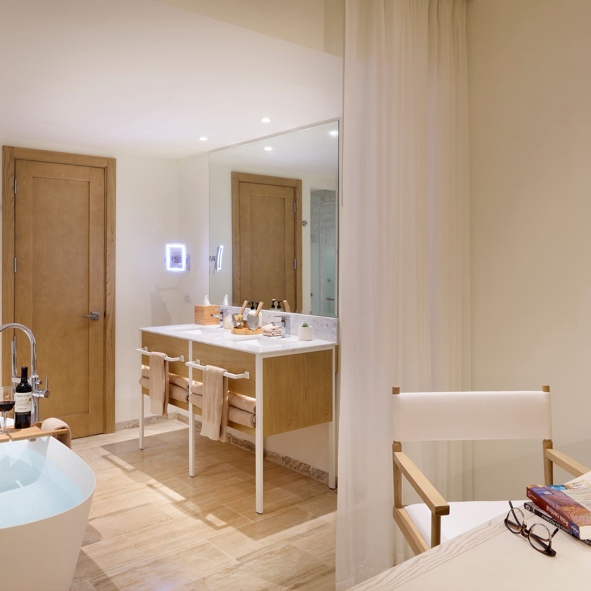 a bathroom with a white tub and a white table