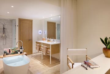 a bathroom with a white tub and a white table