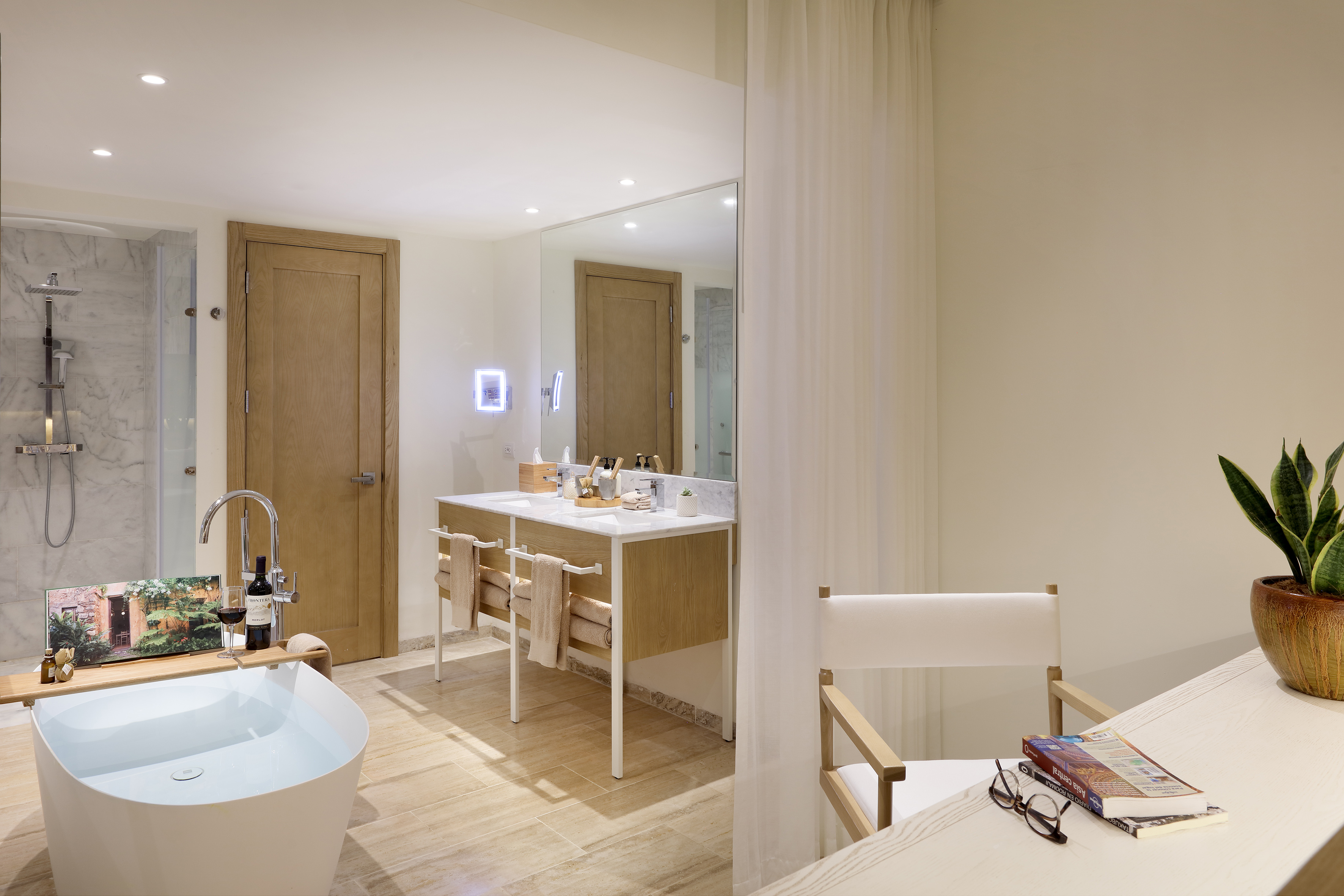 Modern bathroom with freestanding tub, marble shower, and double vanity.